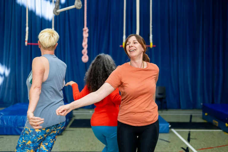 Smiling women enjoying a group fitness class together