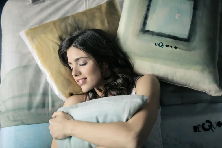 Young woman sleeping peacefully while hugging a pillow